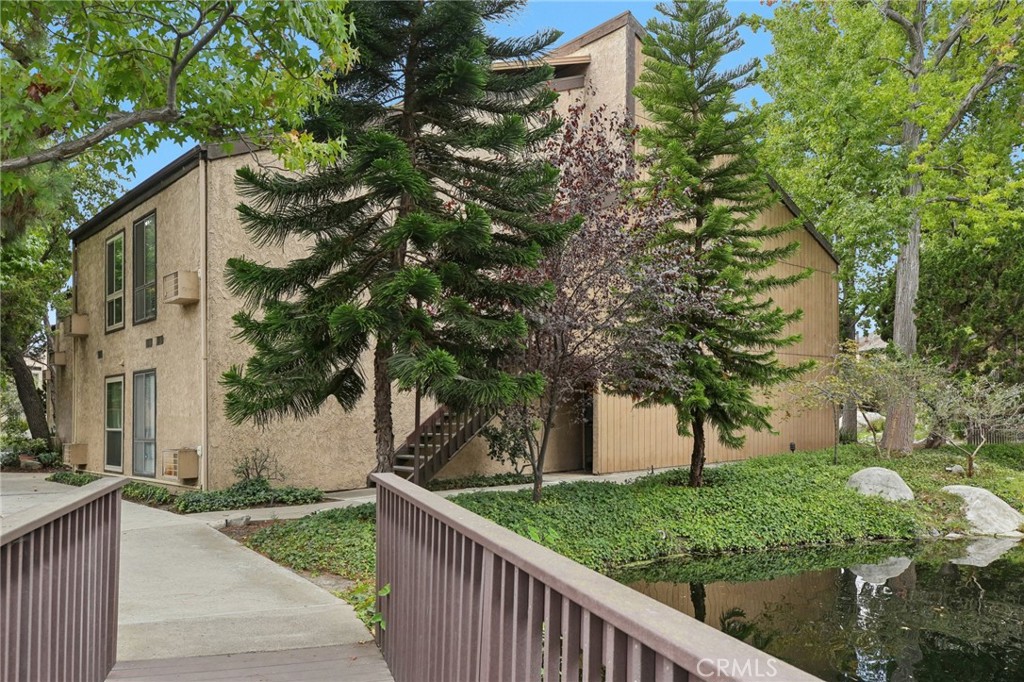 7890 East Spring Street, Unit 16P Long Beach, CA 90815 - Photo 25 of 25 a view of a house with a tree in front of it