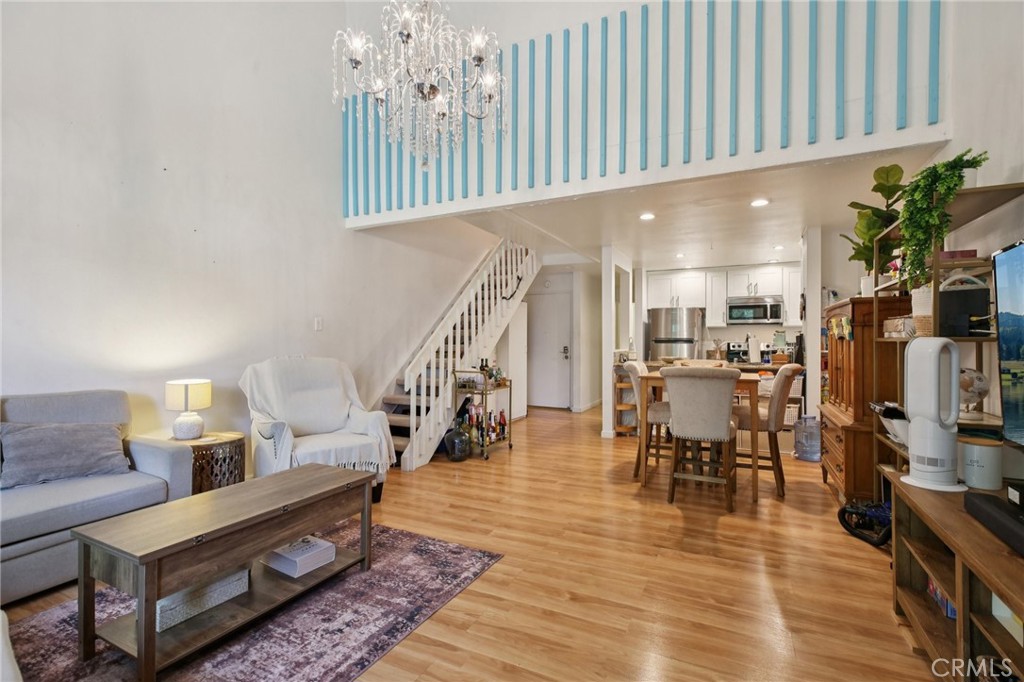 7890 East Spring Street, Unit 16P Long Beach, CA 90815 - Photo 3 of 25 a living room with furniture and a wooden floor