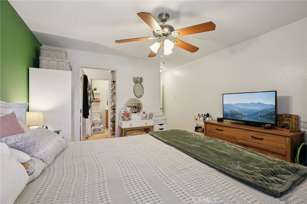 7890 East Spring Street, Unit 16P Long Beach, CA 90815 - Photo 10 of 25 a bedroom with a bed and a flat screen tv