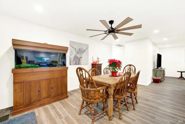 a dining room with furniture and wooden floor
