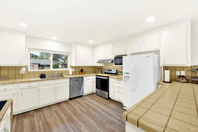a kitchen with a sink stove and cabinets