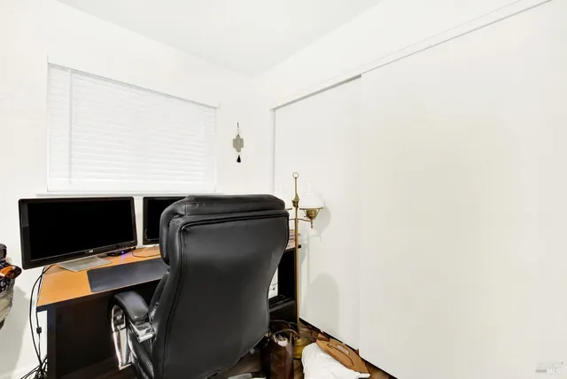 a living room with furniture gym equipment and a rug