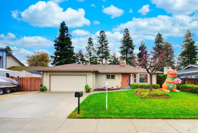 a front view of a house with a garden and plants