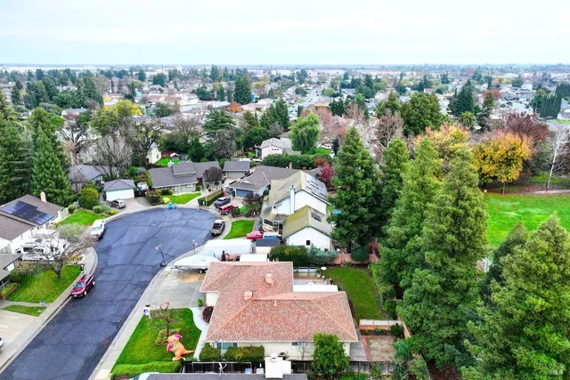 a view of a house with backyard and sitting area