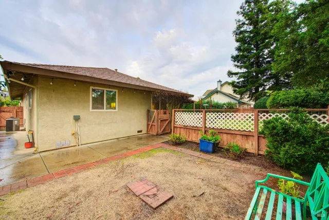 a view of a patio with a table chairs and a backyard