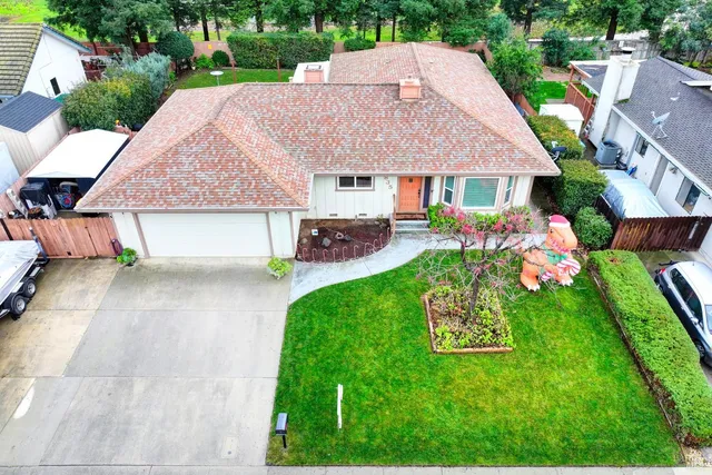 a front view of a house with a garden and plants