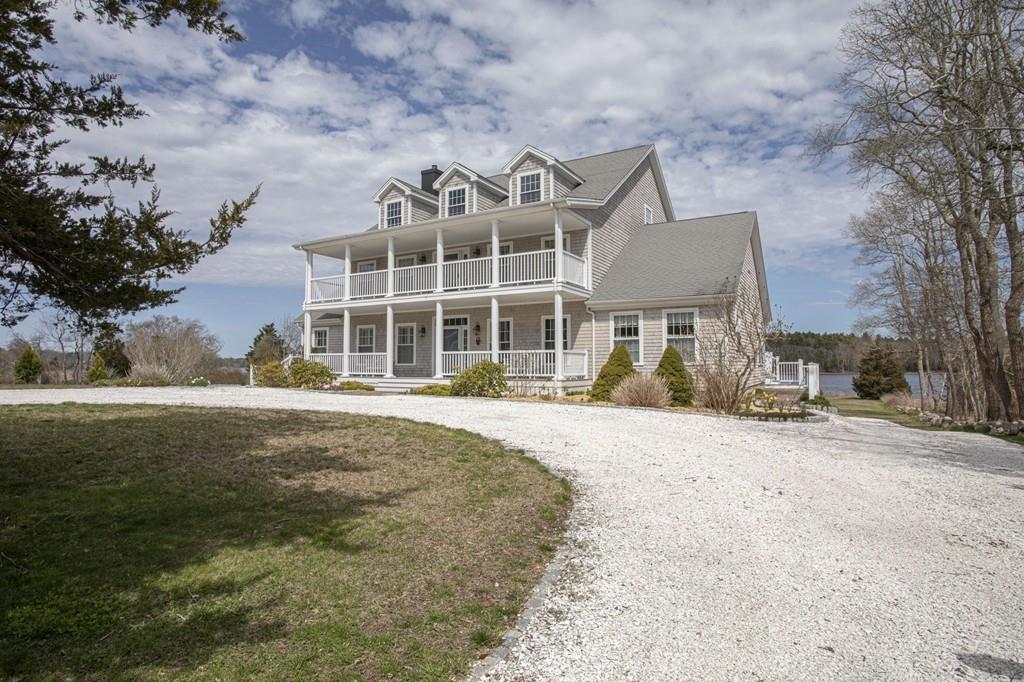 922 Drift Road Westport, MA 02790 - Photo 4 of 42 a front view of a house with a yard and garage