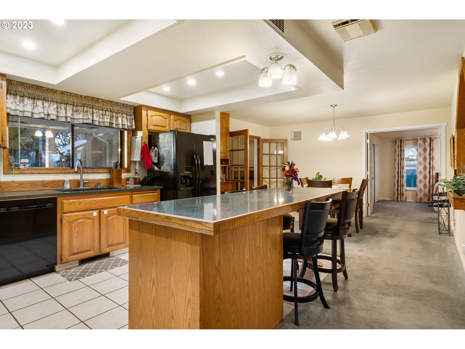 345 3rd Street Northeast Irrigon, OR 97844 - Photo 13 of 39 a kitchen with stainless steel appliances kitchen island granite countertop a table and chairs