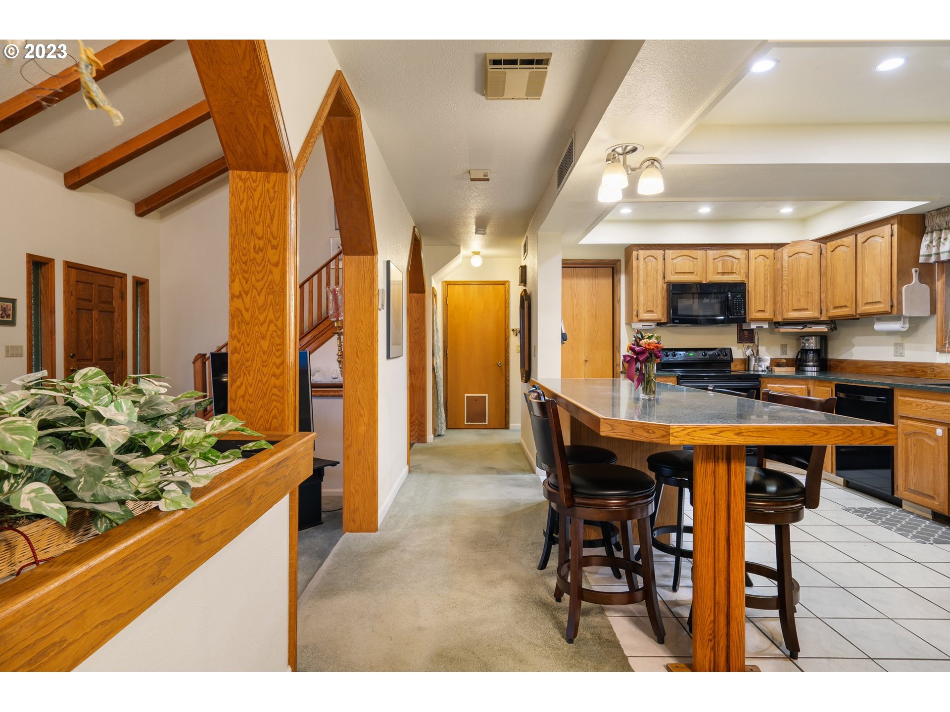345 3rd Street Northeast Irrigon, OR 97844 - Photo 10 of 39 a kitchen with stainless steel appliances kitchen island granite countertop a table chairs sink and cabinets
