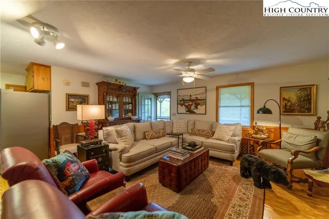 a living room with furniture and a chandelier