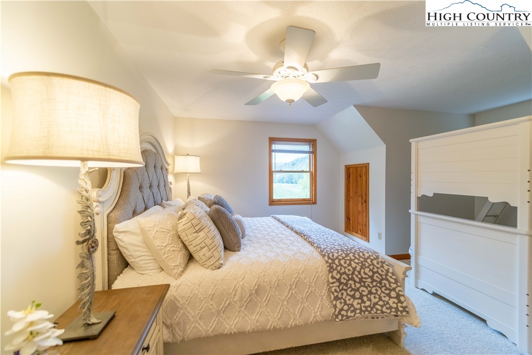 2161 River Bend Road Mouth Of Wilson, VA 24363 - Photo 27 of 47 a bedroom with a bed and a chandelier