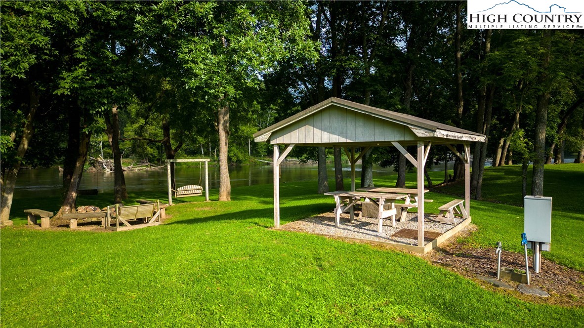2161 River Bend Road Mouth Of Wilson, VA 24363 - Photo 3 of 47 a view of a chair and table with umbrella in the garden