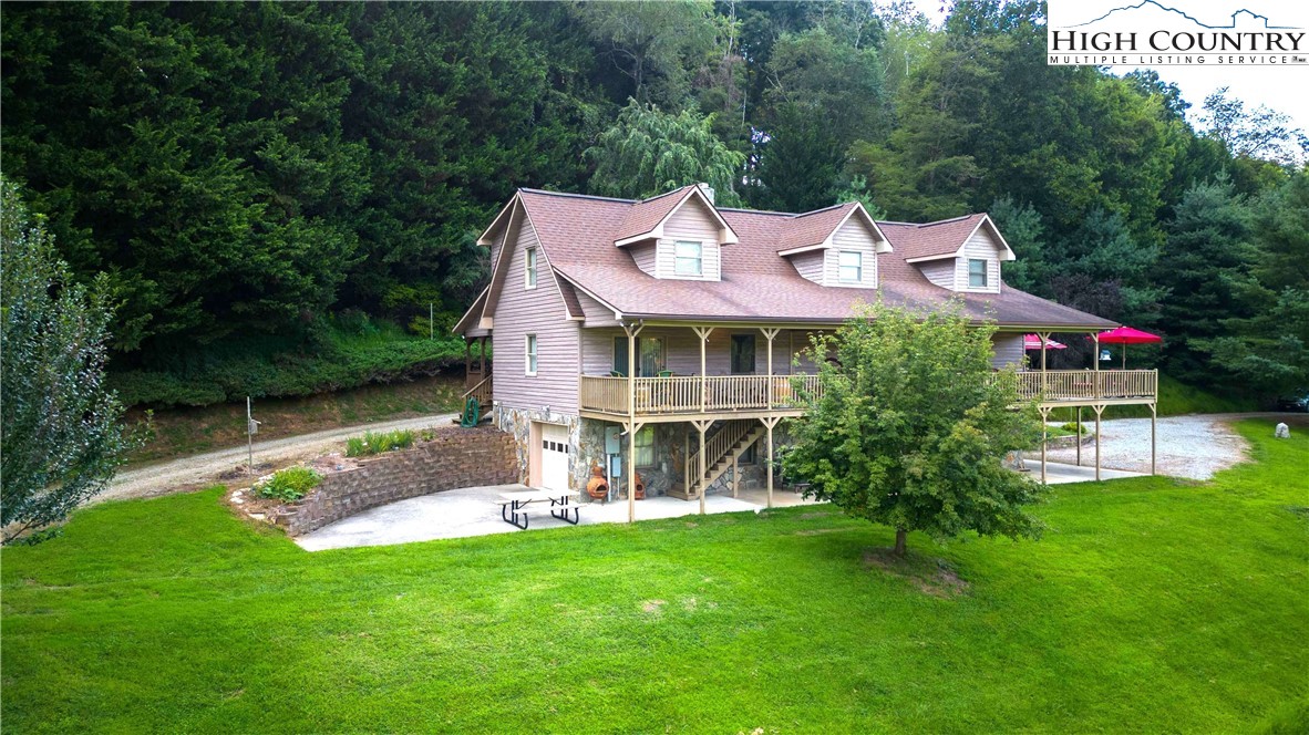 2161 River Bend Road Mouth Of Wilson, VA 24363 - Photo 6 of 47 a front view of a house with a yard table and chairs