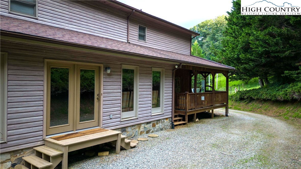 2161 River Bend Road Mouth Of Wilson, VA 24363 - Photo 8 of 47 a backyard of a house with barbeque oven table and chairs