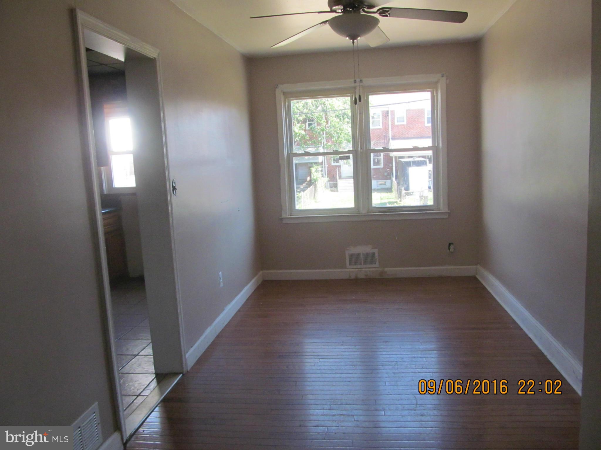 2106 Redthorn Road Baltimore, MD 21220 - Photo 3 of 13 an empty room with wooden floor and windows