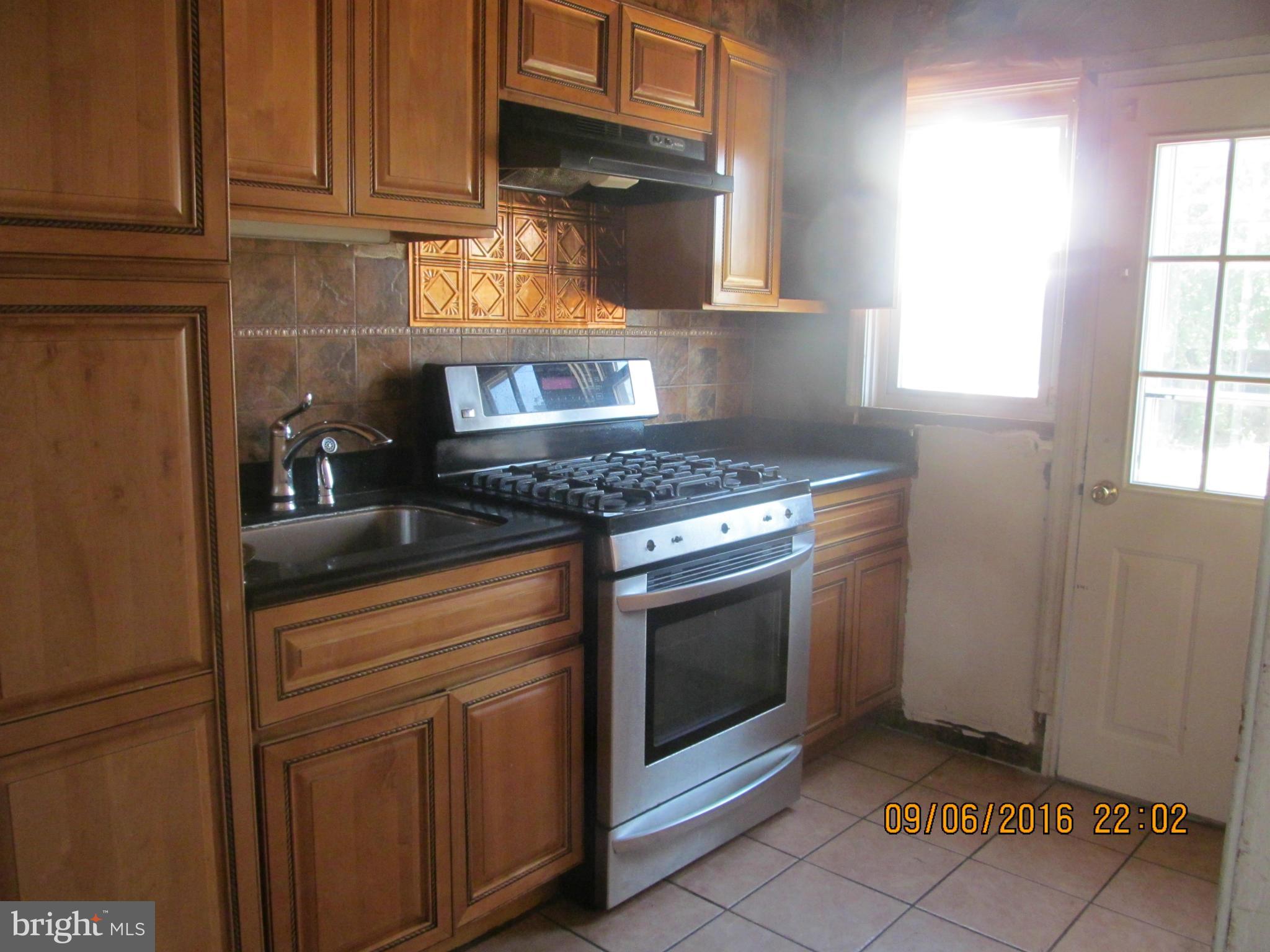2106 Redthorn Road Baltimore, MD 21220 - Photo 4 of 13 a kitchen with stainless steel appliances granite countertop a stove a sink and a microwave