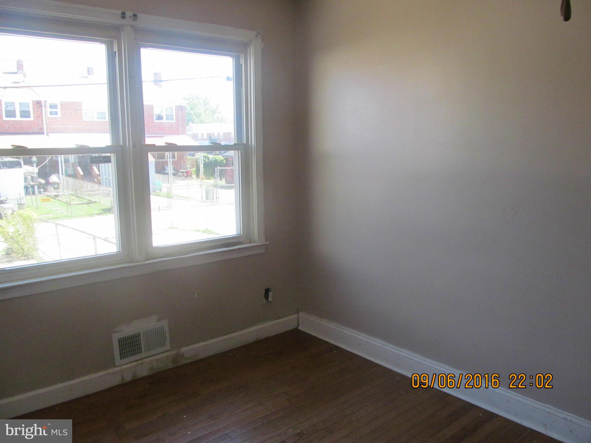 2106 Redthorn Road Baltimore, MD 21220 - Photo 8 of 13 an empty room with wooden floor and windows