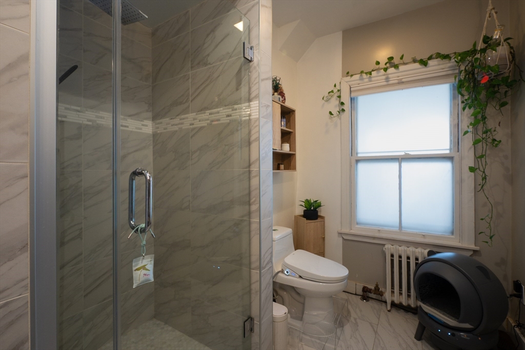 11 Wayne Street Boston, MA 02121 - Photo 16 of 27 a bathroom with a toilet and a shower