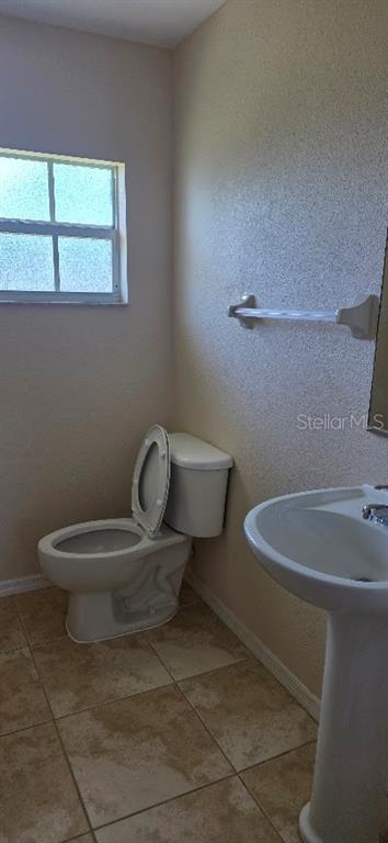 26201 Explorer Road, Unit 5 Punta Gorda, FL 33983 - Photo 11 of 11 a bathroom with a toilet sink and mirror