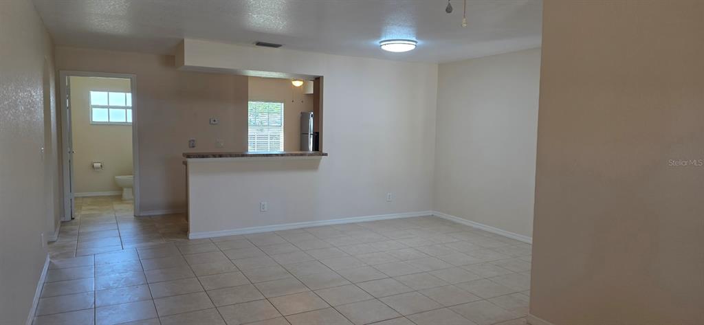26201 Explorer Road, Unit 5 Punta Gorda, FL 33983 - Photo 2 of 11 an empty room with mirror and windows