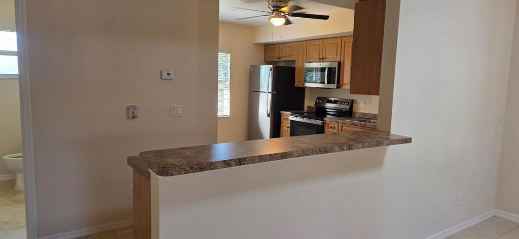 26201 Explorer Road, Unit 5 Punta Gorda, FL 33983 - Photo 4 of 11 a view of living room with granite countertop couches and fireplace