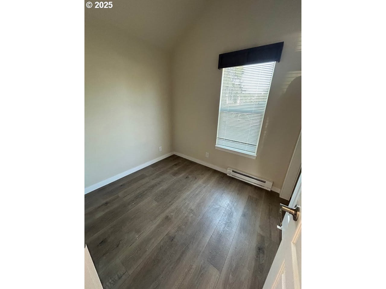 4130 State Street, Unit 9 Salem, OR 97301 - Photo 12 of 14 a view of an empty room with wooden floor and a window
