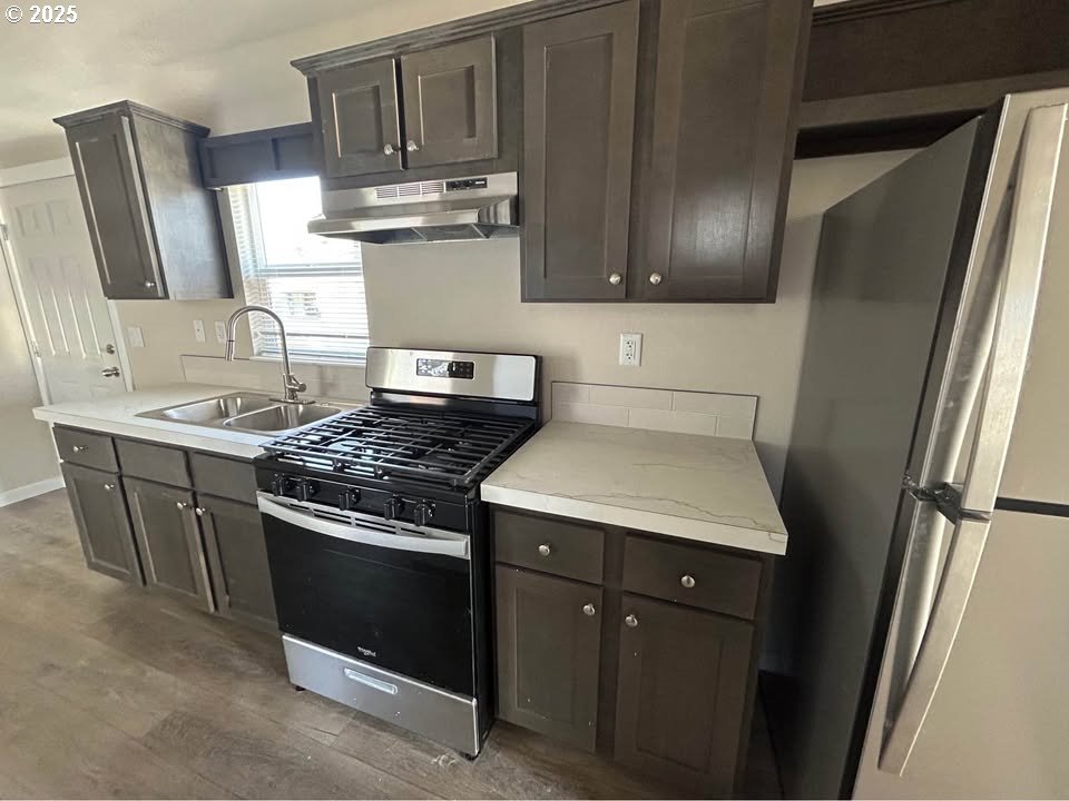 4130 State Street, Unit 9 Salem, OR 97301 - Photo 3 of 14 a kitchen with stainless steel appliances granite countertop a stove a refrigerator and a sink