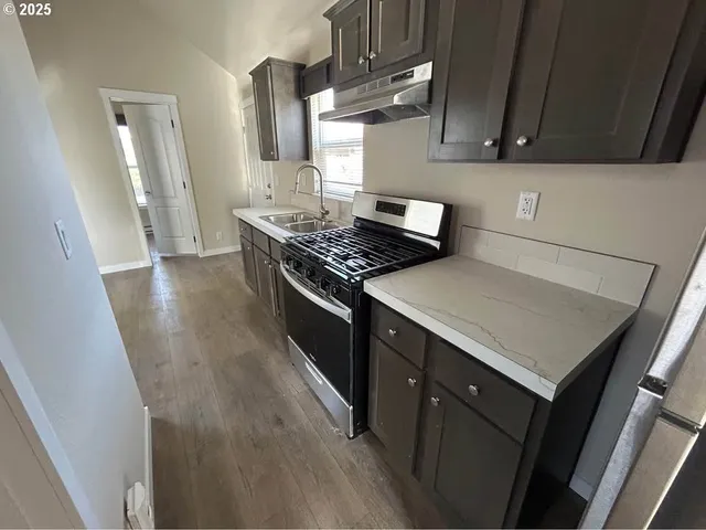 a kitchen with a stove and a sink