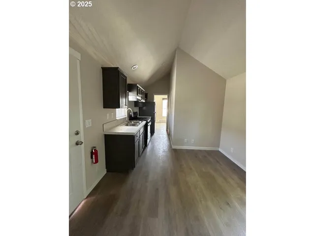 a view of a kitchen from a hallway