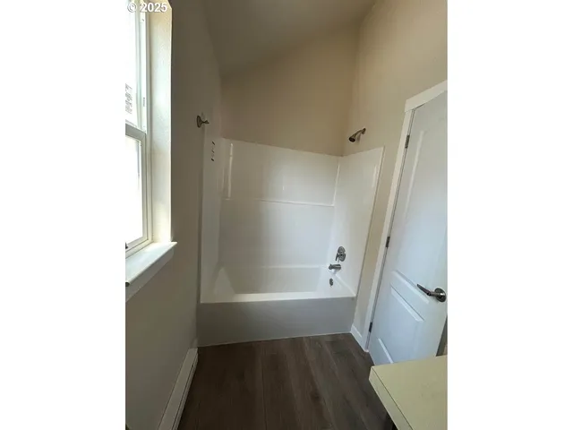a bathroom with a tub and shower