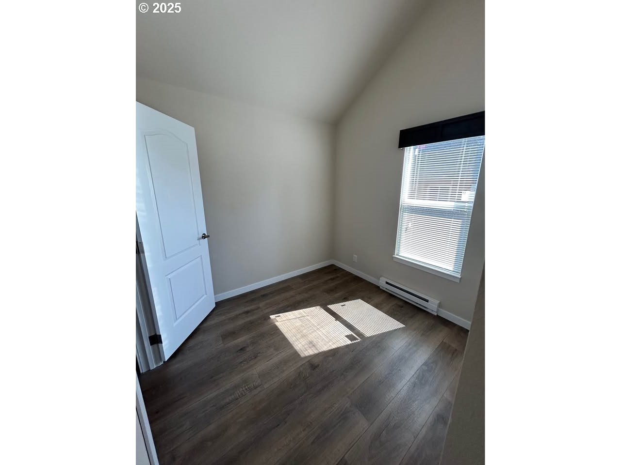 4130 State Street, Unit 9 Salem, OR 97301 - Photo 10 of 14 a view of an empty room with wooden floor and a window