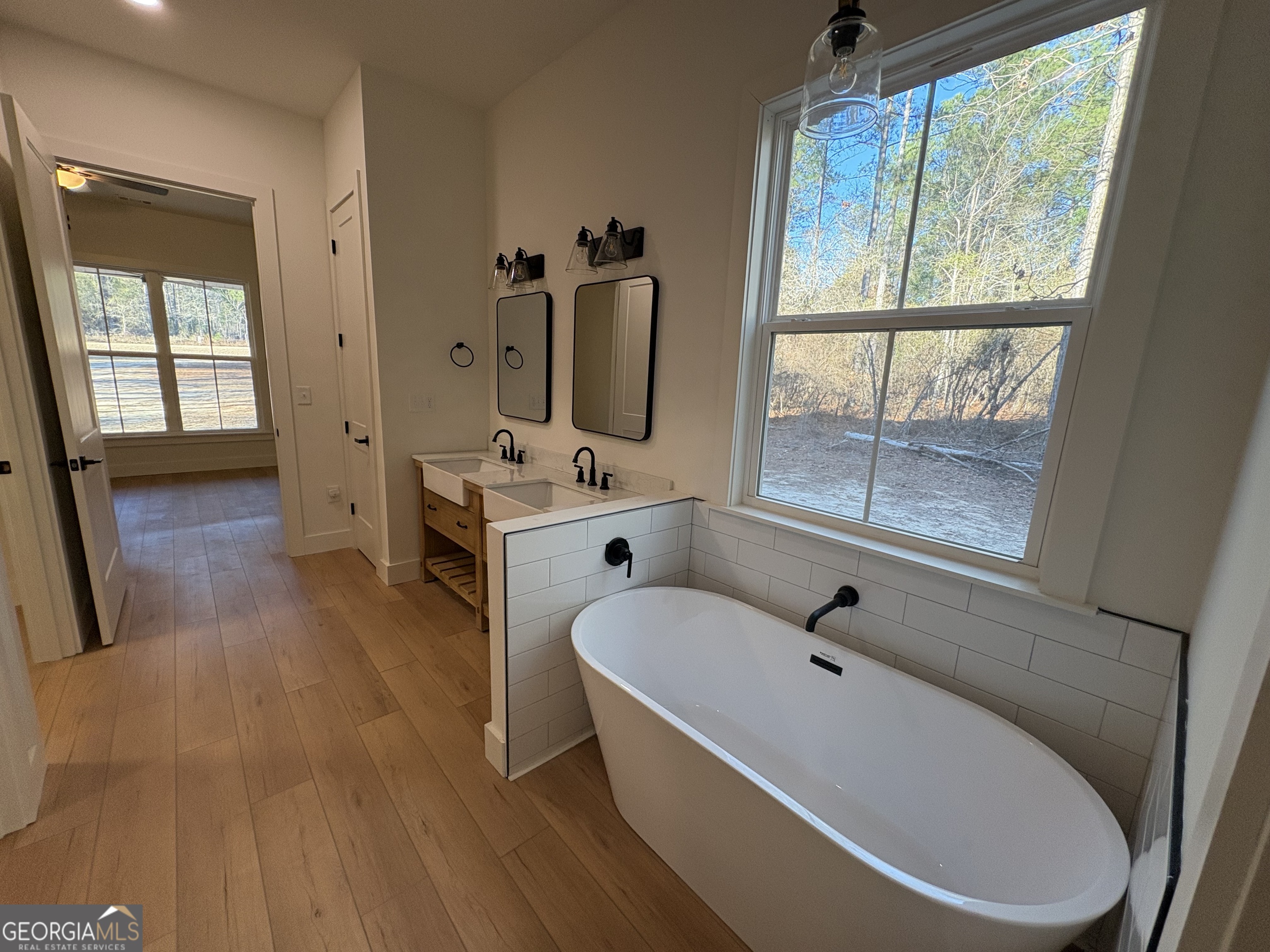 435 Muskogee Trail Dublin, GA 31021 - Photo 18 of 31 a bathroom with a tub a sink and a window