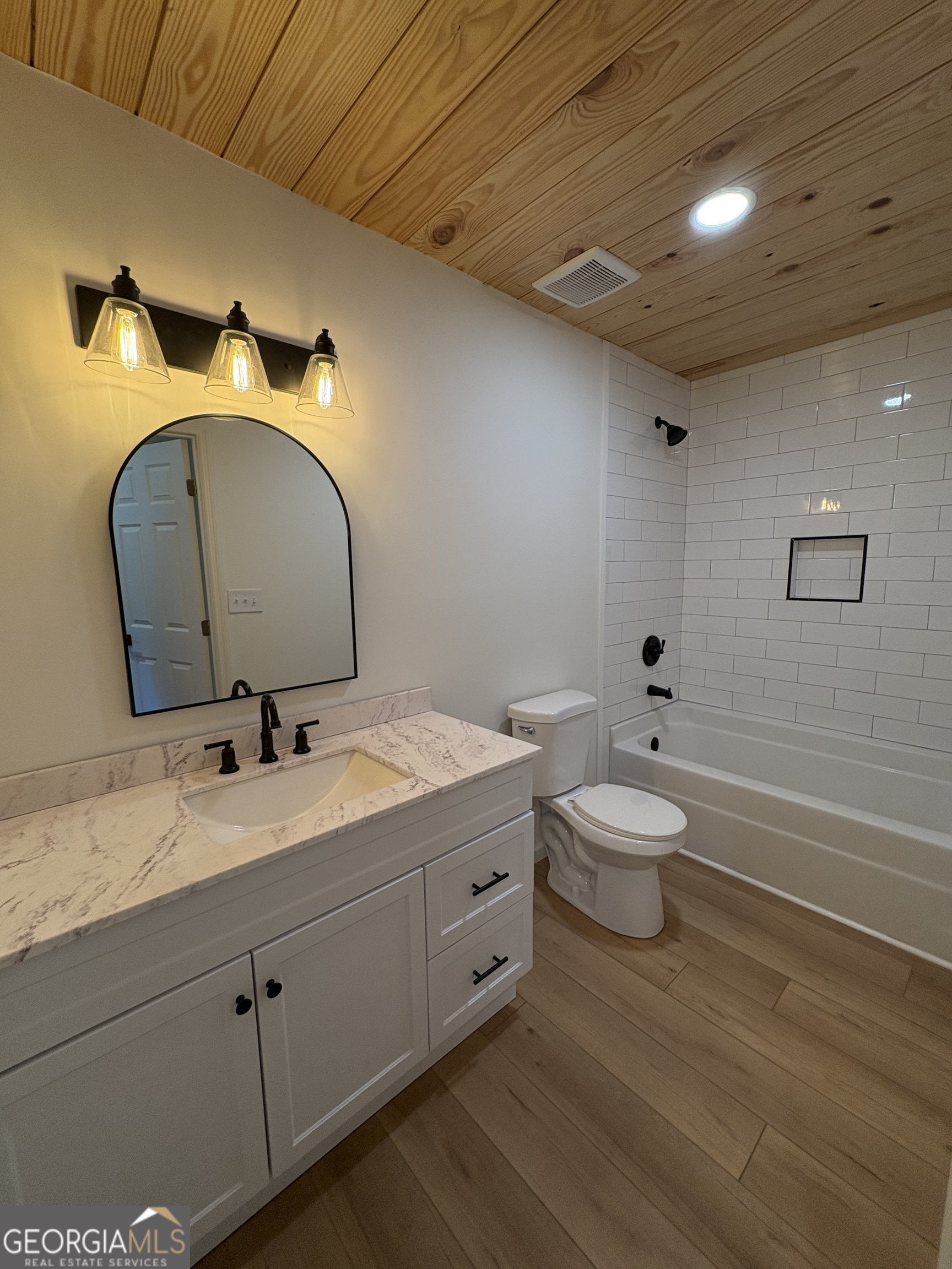 435 Muskogee Trail Dublin, GA 31021 - Photo 22 of 31 a bathroom with a double vanity sink and a mirror