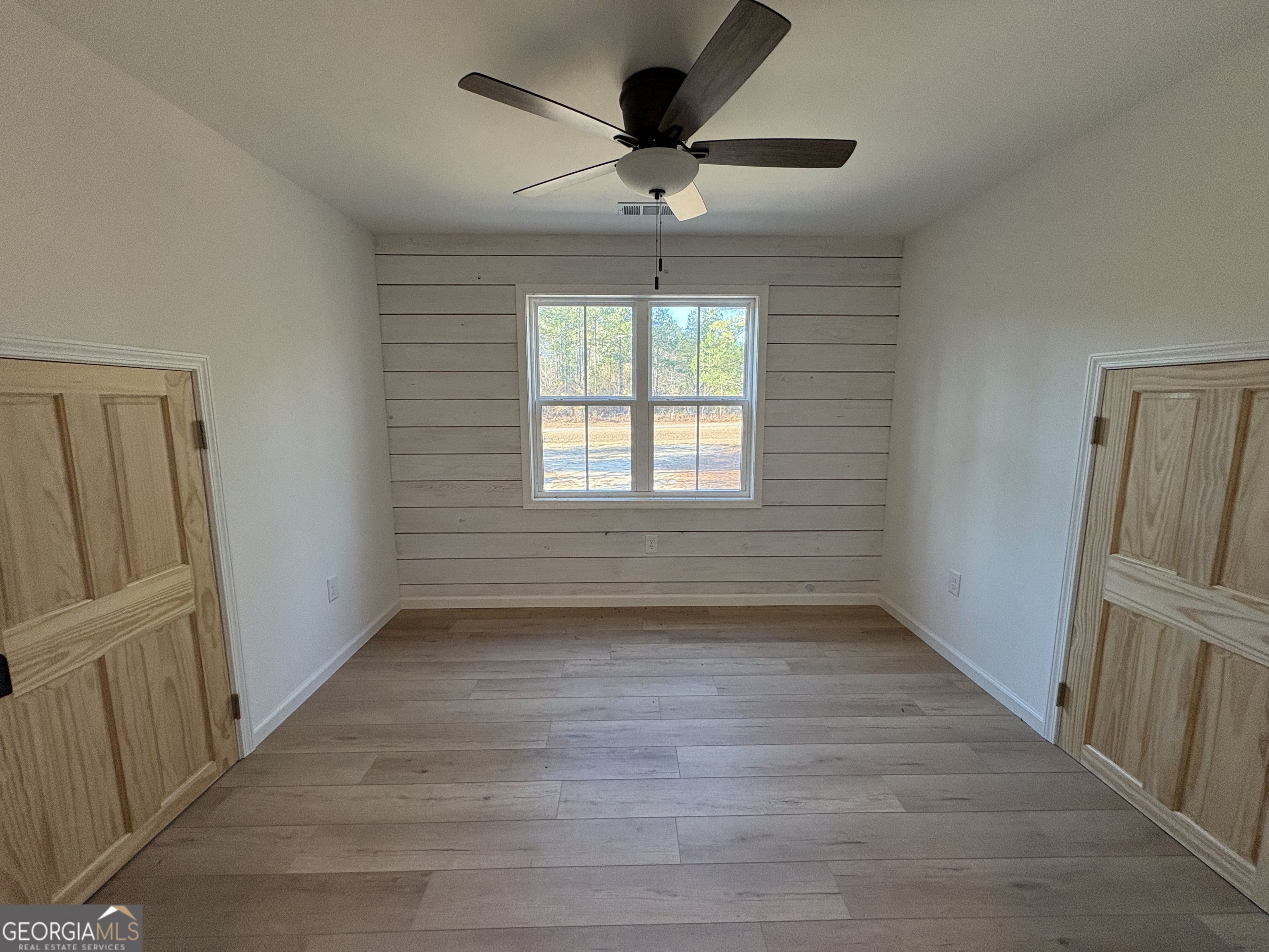 435 Muskogee Trail Dublin, GA 31021 - Photo 28 of 31 wooden floor in an empty room with a window
