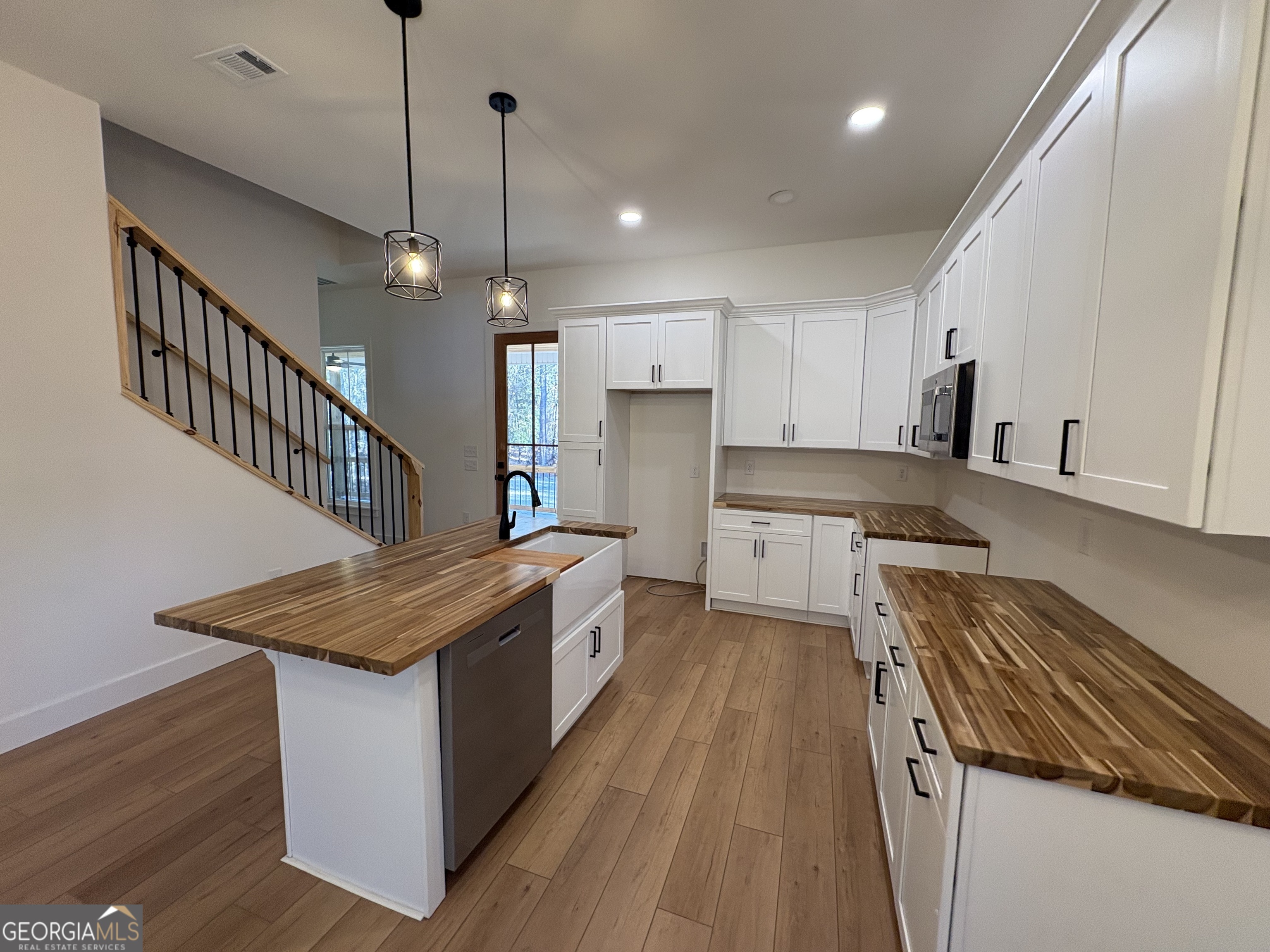 435 Muskogee Trail Dublin, GA 31021 - Photo 7 of 31 a kitchen with a stove a sink and a refrigerator