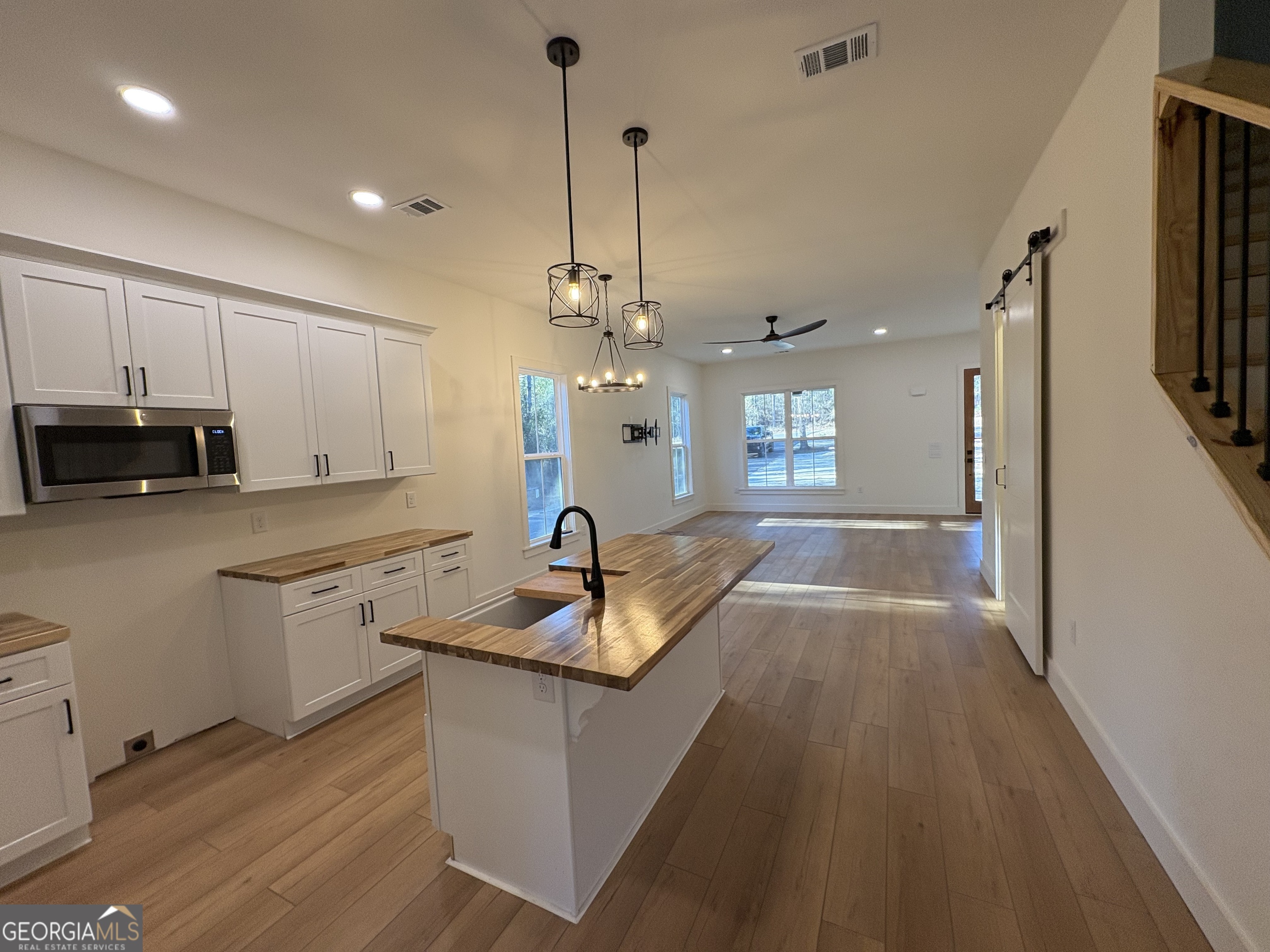 435 Muskogee Trail Dublin, GA 31021 - Photo 9 of 31 a kitchen with granite countertop a sink a counter top space appliances and cabinets