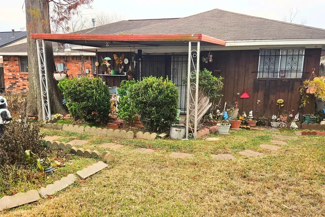 a view of a house with floor to ceiling windows and a yard