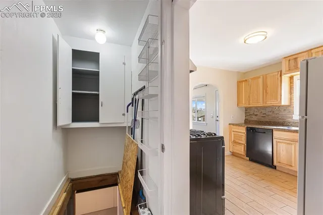 a view of kitchen and hallway with wooden floor