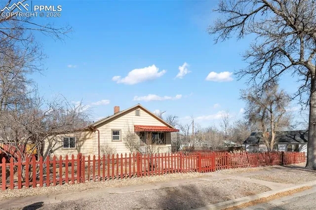 a view of a house with wooden fence