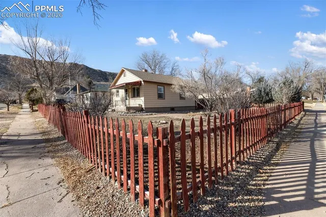 a view of a house with wooden fence