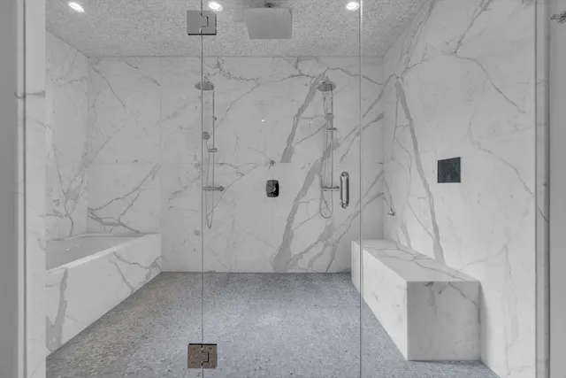 a bathroom with a bathtub and shower