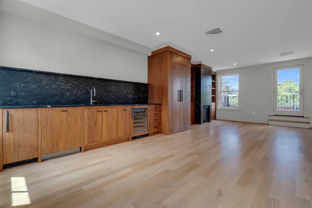 a view of an empty room with a kitchen