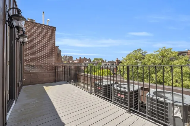 a view of a balcony with wooden floor