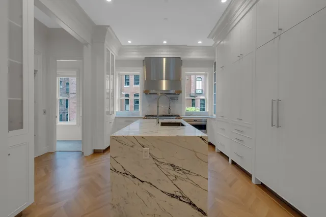a view of a living room with furniture and a wooden floor