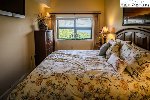 a bathroom with a granite countertop toilet sink and mirror