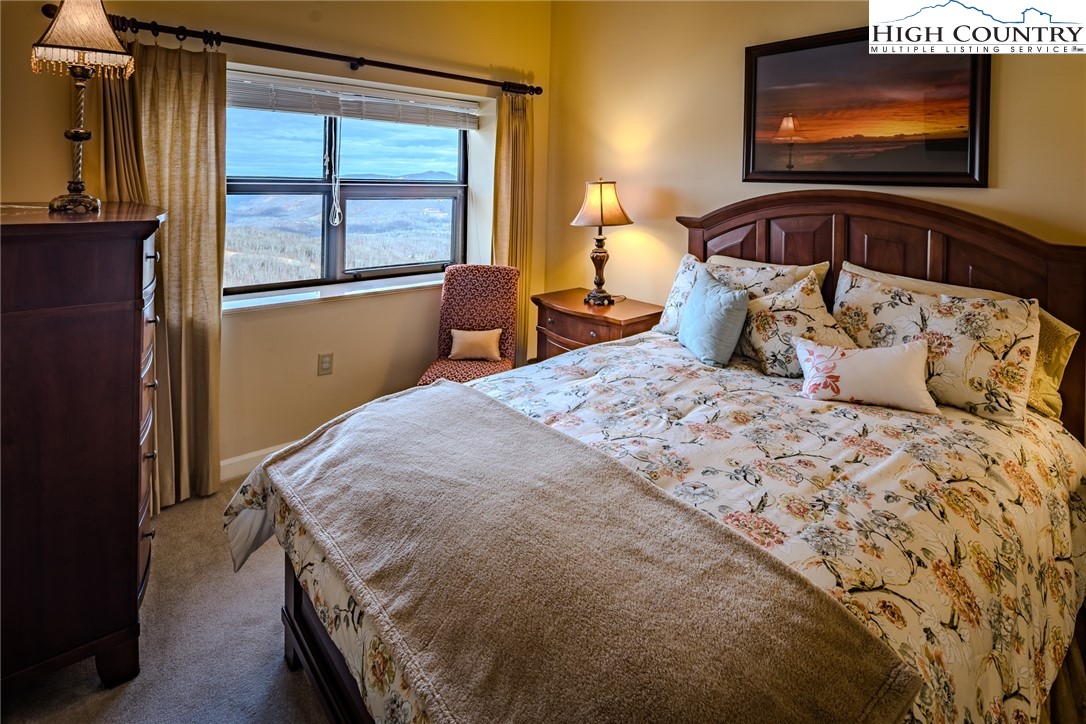 303 Sugar Top Drive, Unit 43427 Sugar Mountain, NC 28604 - Photo 12 of 18 a bedroom with a bed and a flat screen tv