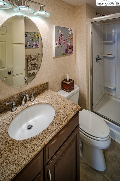 303 Sugar Top Drive, Unit 43427 Sugar Mountain, NC 28604 - Photo 14 of 18 a bathroom with a sink and mirror with toilet