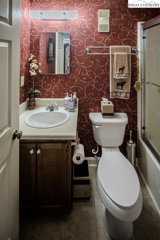 303 Sugar Top Drive, Unit 43427 Sugar Mountain, NC 28604 - Photo 17 of 18 a bathroom with a toilet sink and mirror
