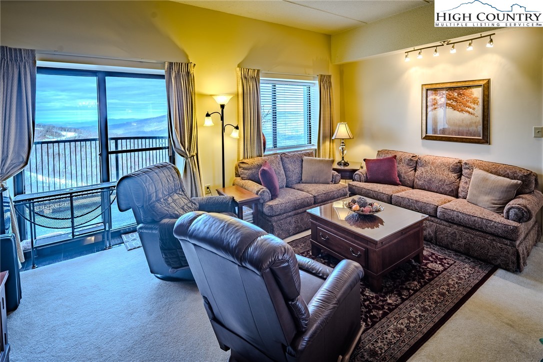 303 Sugar Top Drive, Unit 43427 Sugar Mountain, NC 28604 - Photo 3 of 18 a living room with furniture and a window