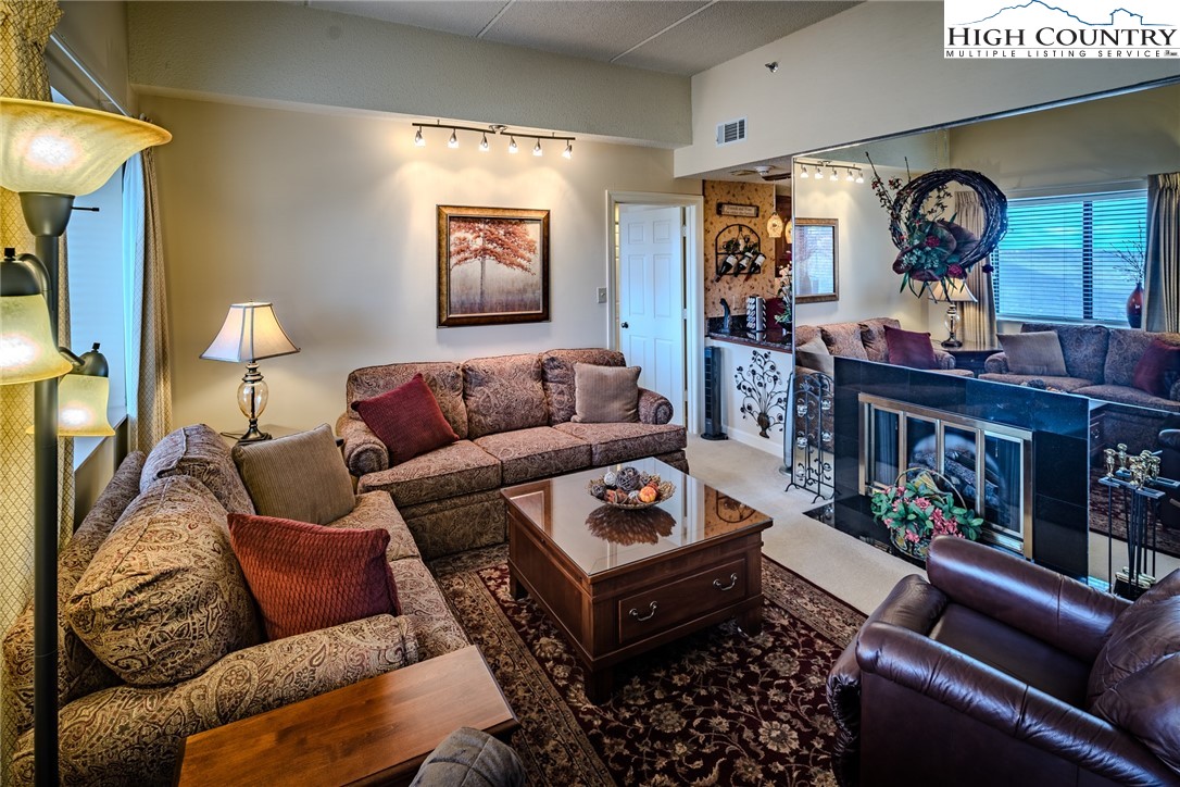 303 Sugar Top Drive, Unit 43427 Sugar Mountain, NC 28604 - Photo 4 of 18 a living room with furniture and a wooden floor